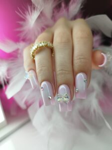 ozdoby na lekko różowych paznokciach